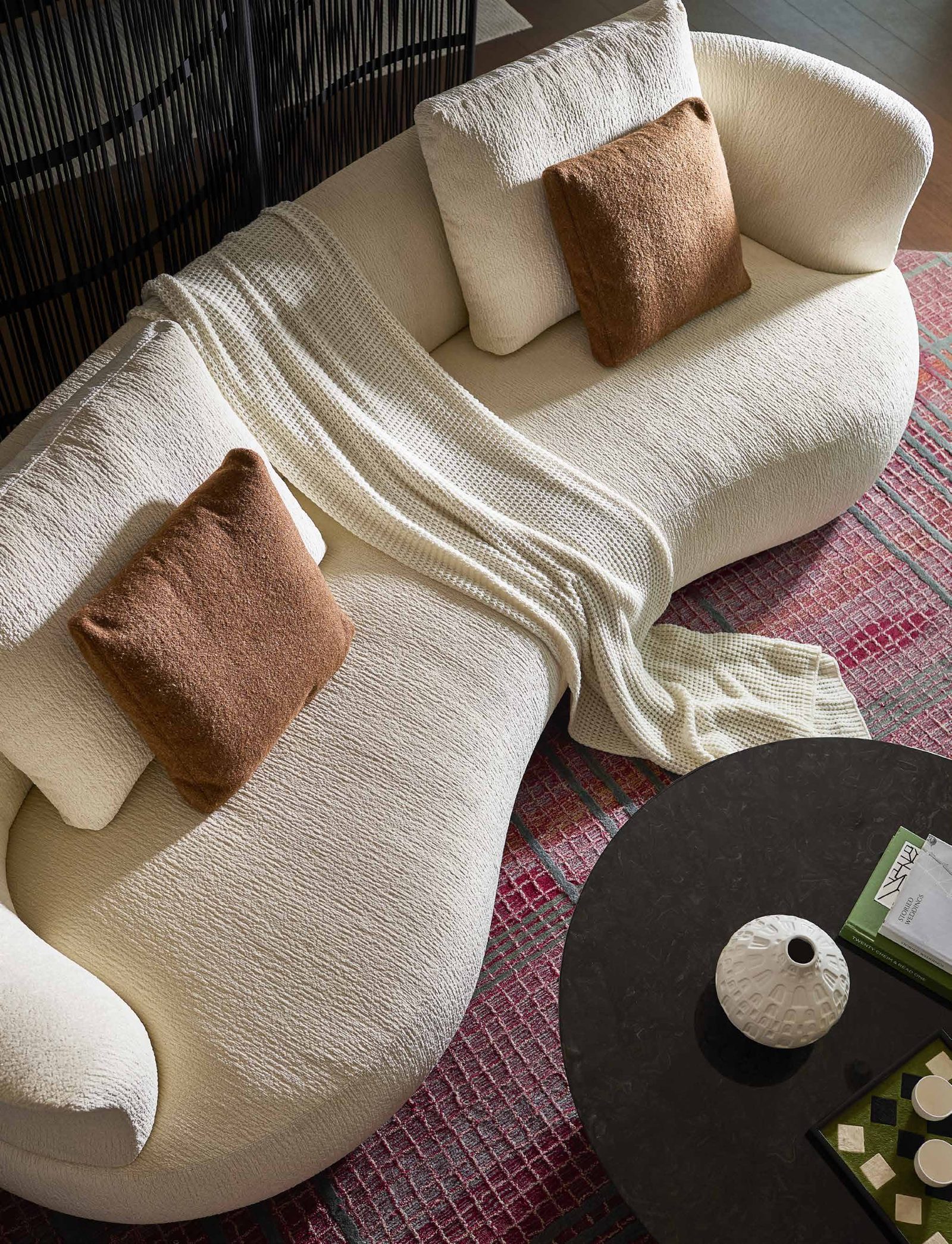 Sande Sofa — Curved Embrace, Serene Relaxation, styled in a luxury living room
